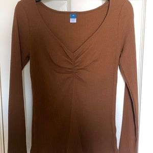 Brown long sleeve cinched front rib knit shirt for women.